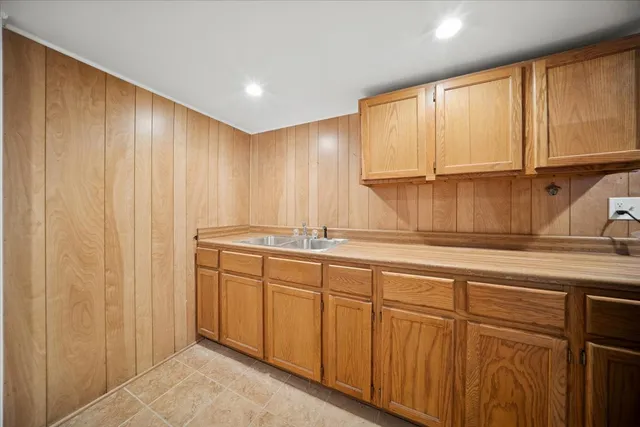 a kitchen with stainless steel appliances granite countertop white cabinets and a sink