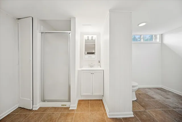 a bathroom with a toilet and a shower