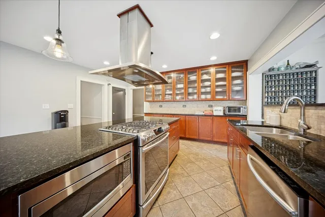 a kitchen with stainless steel appliances granite countertop a stove and a sink