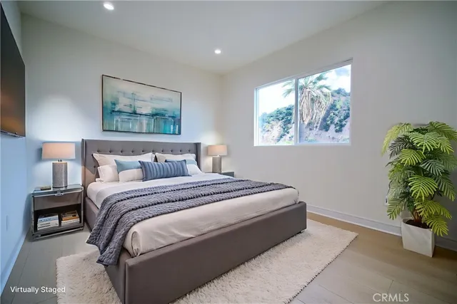 a bedroom with a bed and a painting on the wall