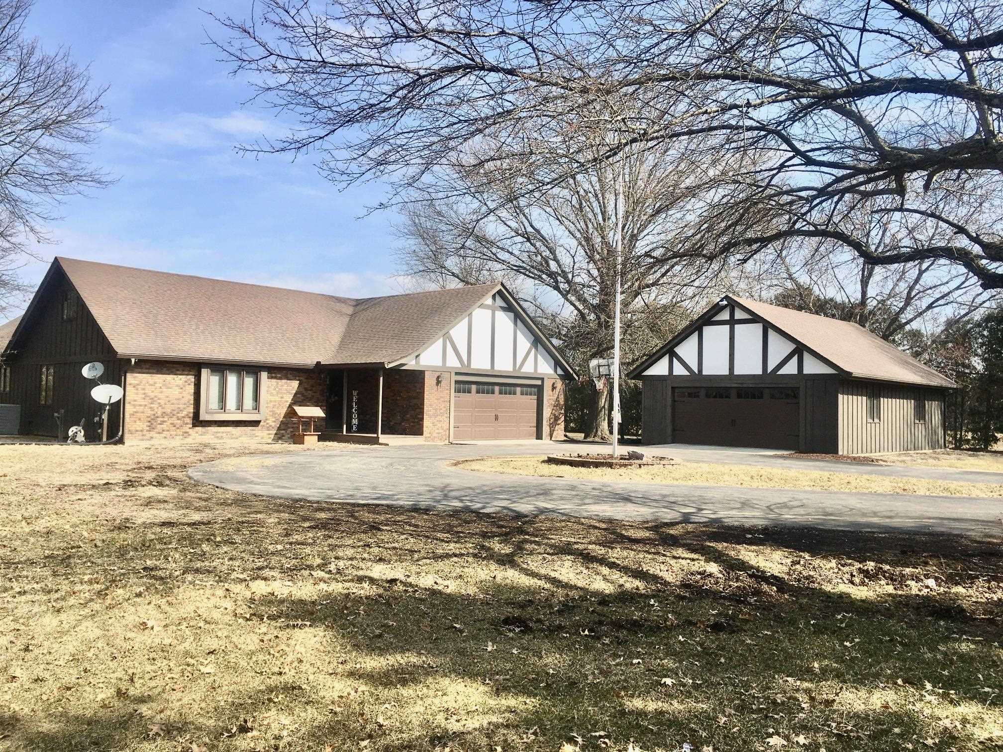 256 Spring Creek Road Rockford, IL 61114 - Photo 1 of 29 a big house with large trees and wooden fence