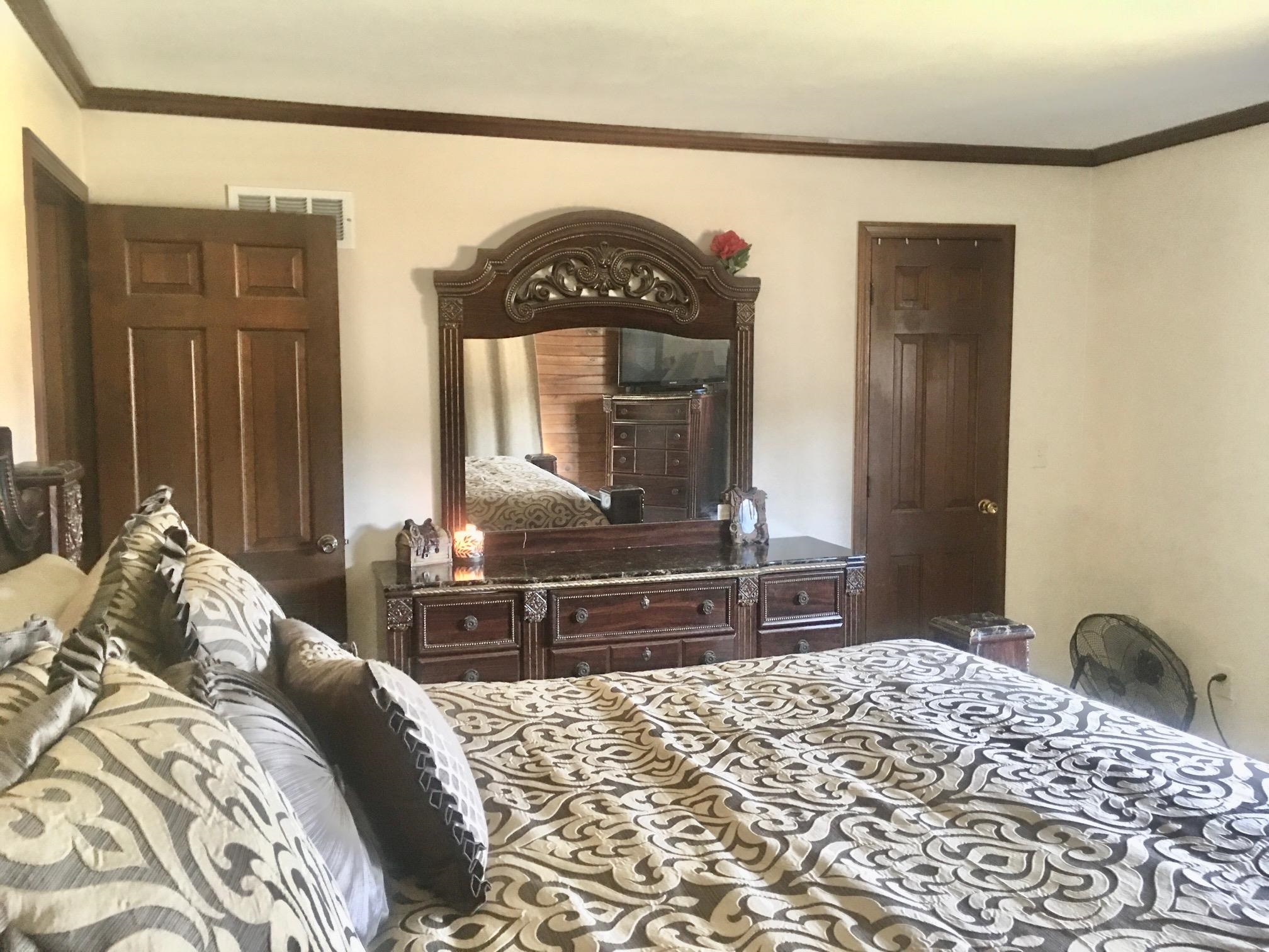 256 Spring Creek Road Rockford, IL 61114 - Photo 14 of 29 a bedroom with a bed and a large mirror with a dresser