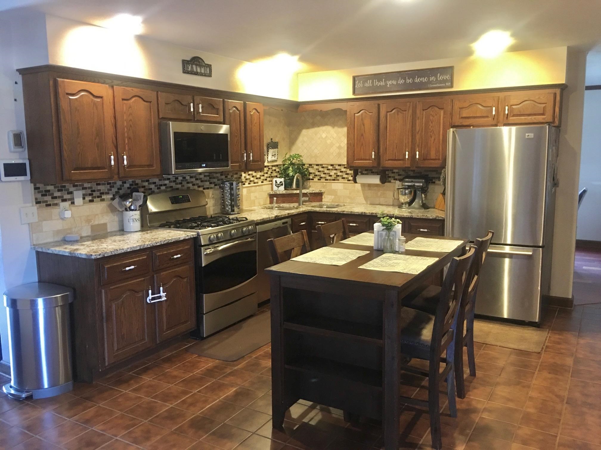 256 Spring Creek Road Rockford, IL 61114 - Photo 2 of 29 a kitchen with a sink appliances and cabinets
