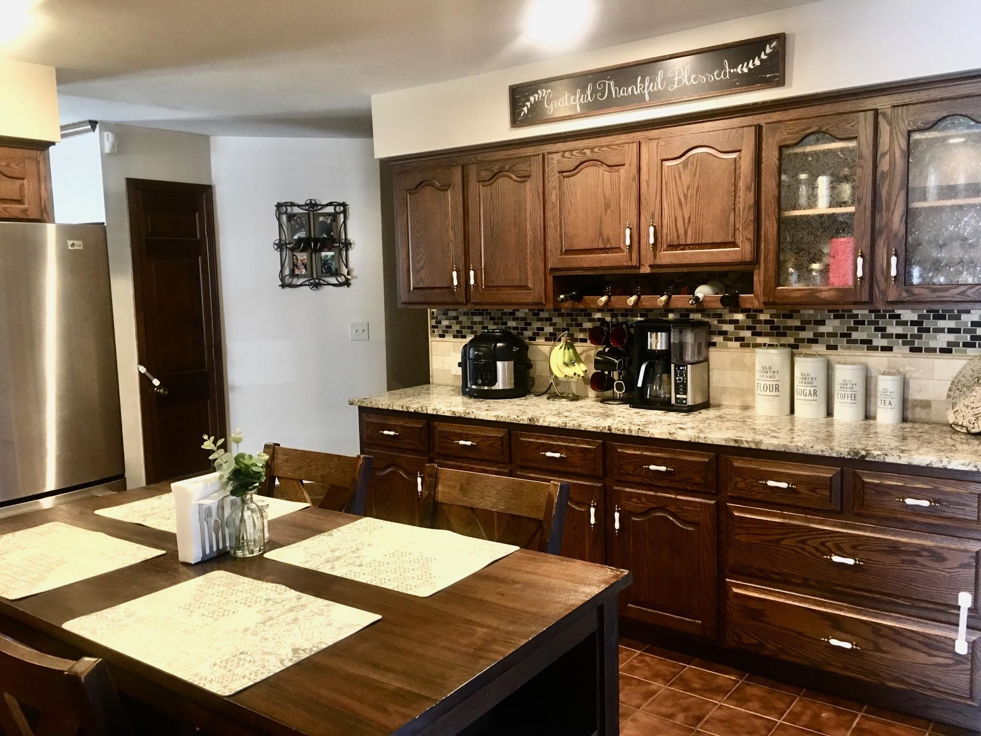 256 Spring Creek Road Rockford, IL 61114 - Photo 4 of 29 a kitchen with a sink refrigerator and cabinets