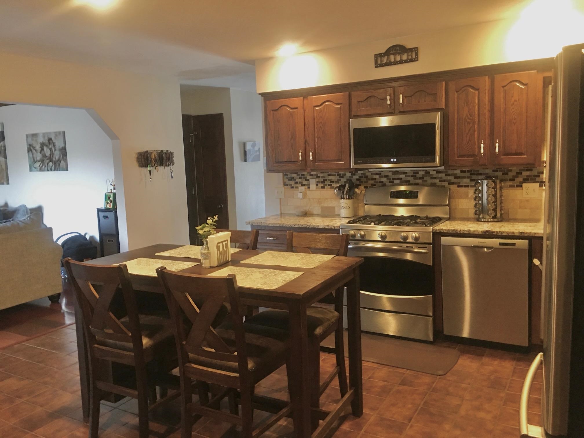 256 Spring Creek Road Rockford, IL 61114 - Photo 5 of 29 a kitchen with a sink stove and microwave