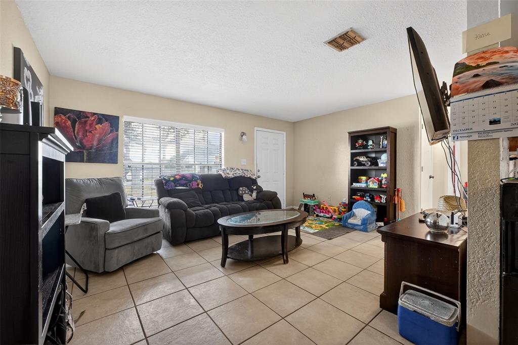 1644 Ruth Street Cocoa, FL 32926 - Photo 9 of 38 a living room with furniture and a flat screen tv