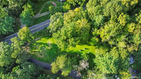 a backyard of a house with lots of green space and a lake view