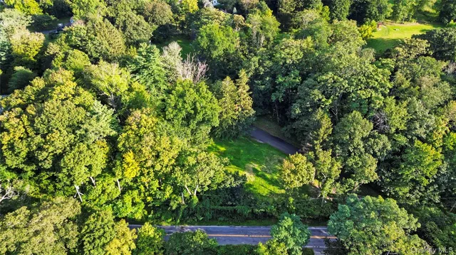 a backyard of a house with lots of green space and garden