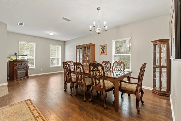 a living room with furniture ceiling fan and a wooden floor