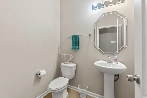 a bathroom with a sink a toilet and mirror