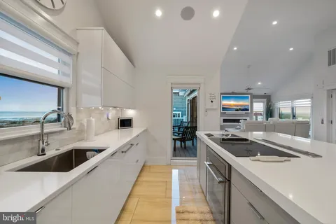 a kitchen with stainless steel appliances granite countertop a sink and a stove