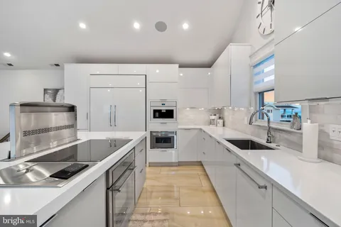 a large kitchen with a table and chairs