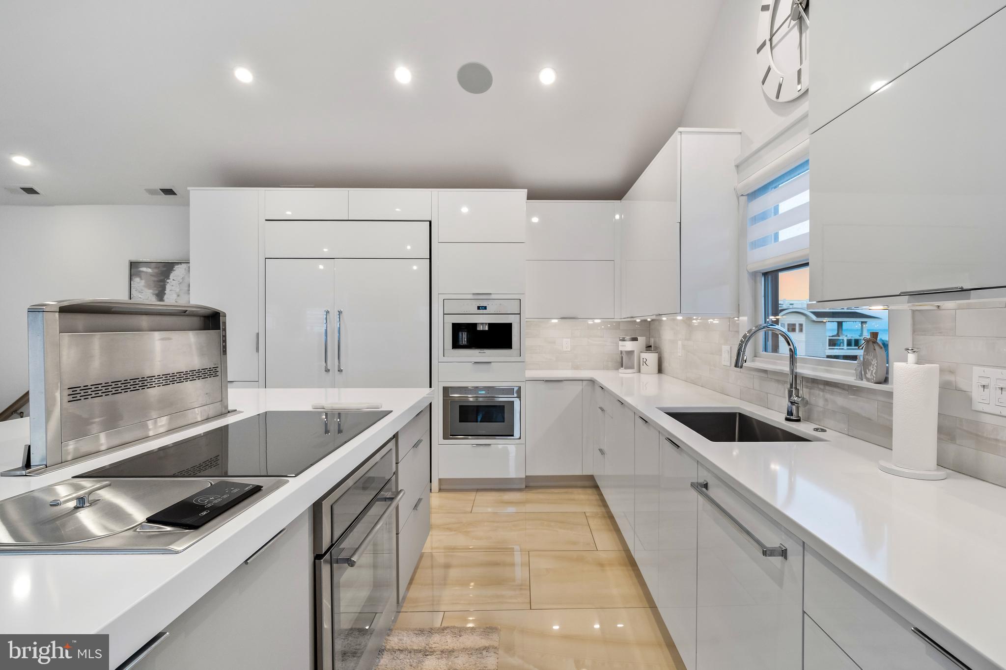 901 South Commonwealth Avenue, Unit SOUTH Strathmere, NJ 08248 - Photo 12 of 66 a kitchen with stainless steel appliances granite countertop a sink and a stove
