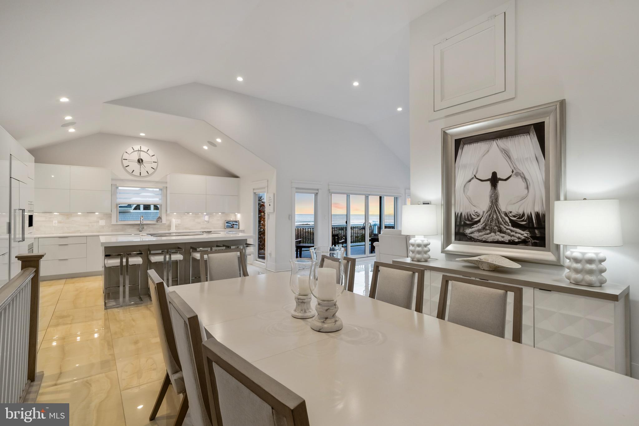 901 South Commonwealth Avenue, Unit SOUTH Strathmere, NJ 08248 - Photo 17 of 66 a kitchen with stainless steel appliances granite countertop a stove a sink a dining table and chairs