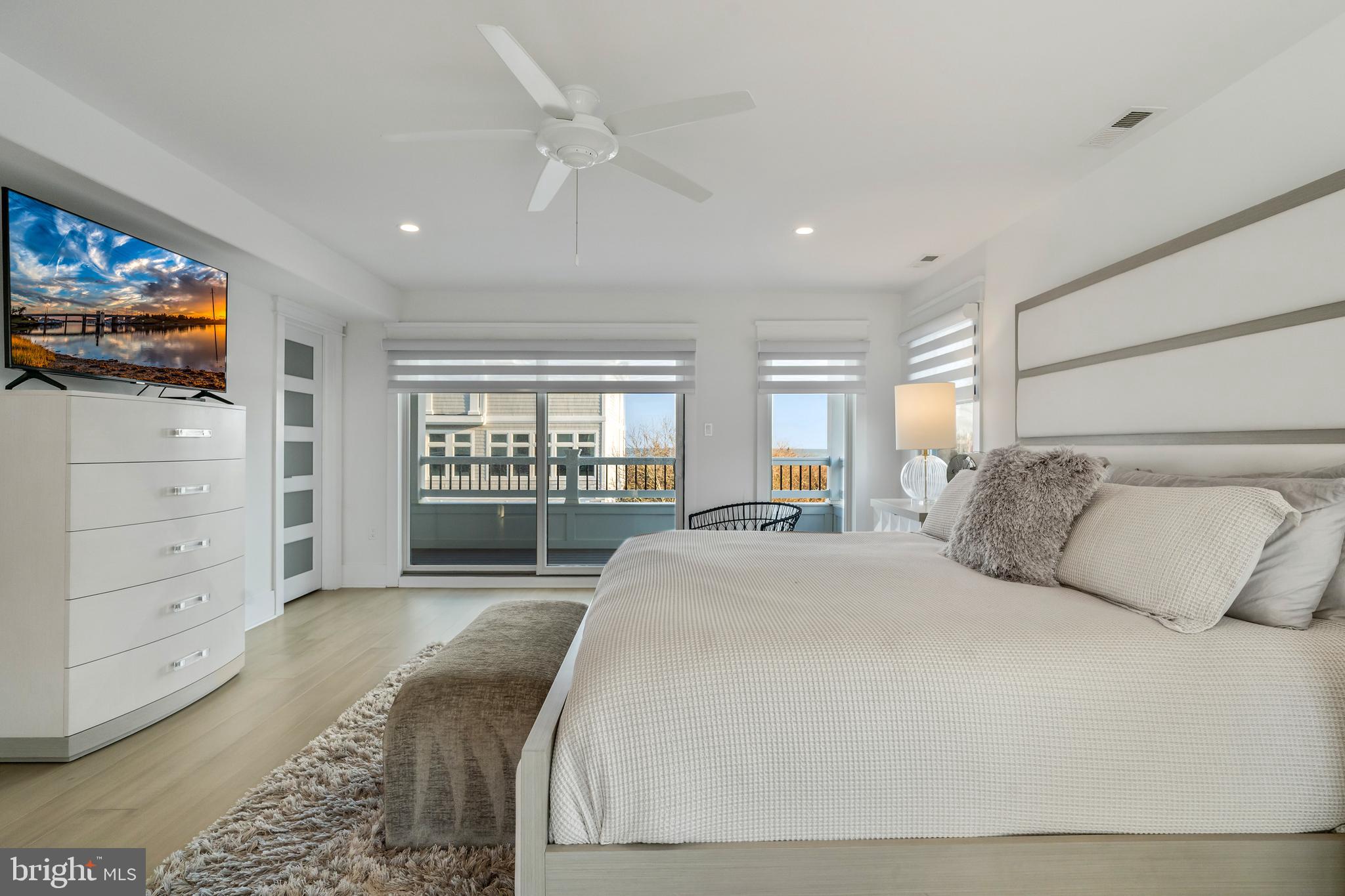 901 South Commonwealth Avenue, Unit SOUTH Strathmere, NJ 08248 - Photo 23 of 66 a spacious bedroom with a large bed and a window