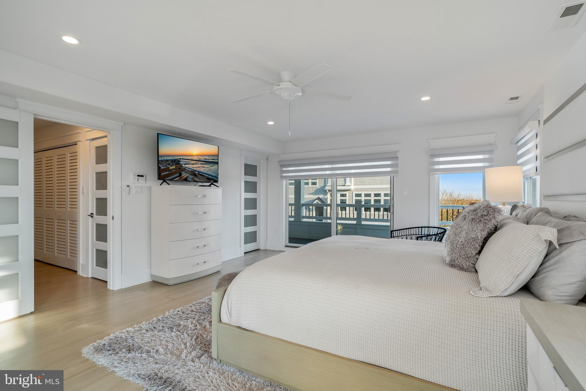 901 South Commonwealth Avenue, Unit SOUTH Strathmere, NJ 08248 - Photo 24 of 66 a bedroom with a bed and wooden floor