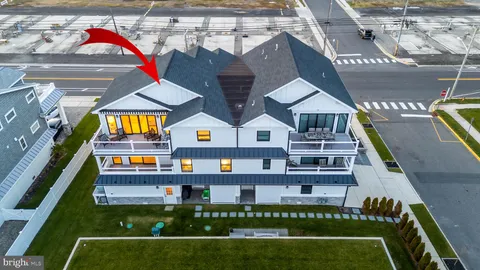 a view of a big building with a big yard and large trees