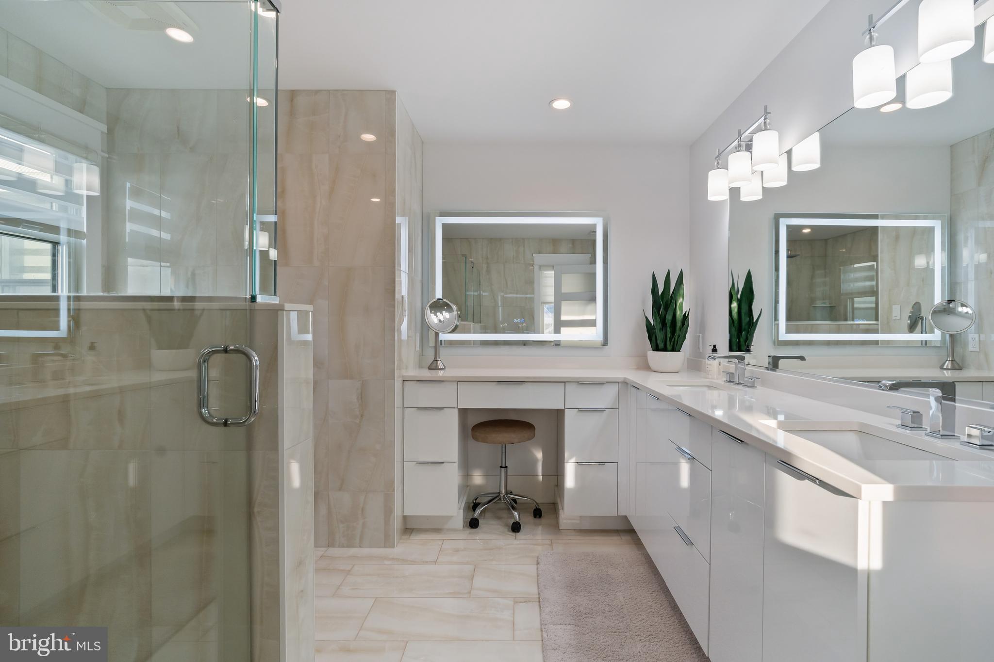 901 South Commonwealth Avenue, Unit SOUTH Strathmere, NJ 08248 - Photo 33 of 66 a bathroom with a double vanity sink mirror and shower
