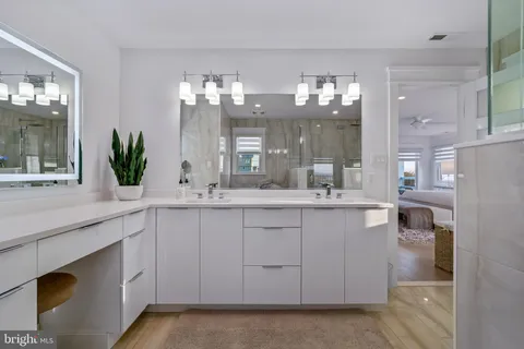 a bathroom with a sink shower and a mirror