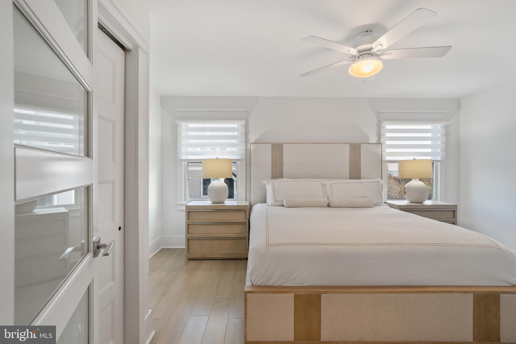 901 South Commonwealth Avenue, Unit SOUTH Strathmere, NJ 08248 - Photo 37 of 66 a bedroom with a bed and a chandelier