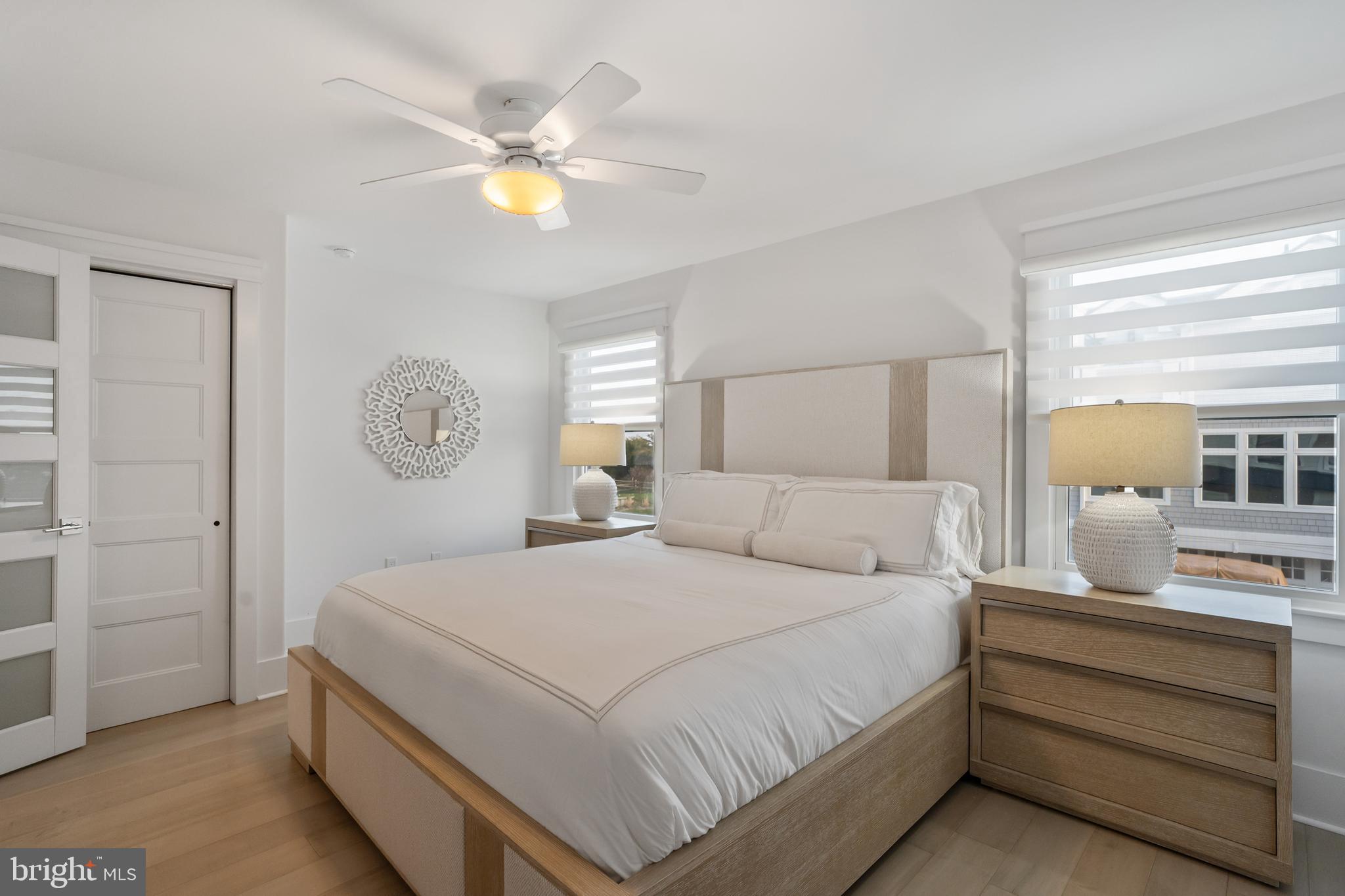 901 South Commonwealth Avenue, Unit SOUTH Strathmere, NJ 08248 - Photo 38 of 66 a bedroom with a bed and a chandelier