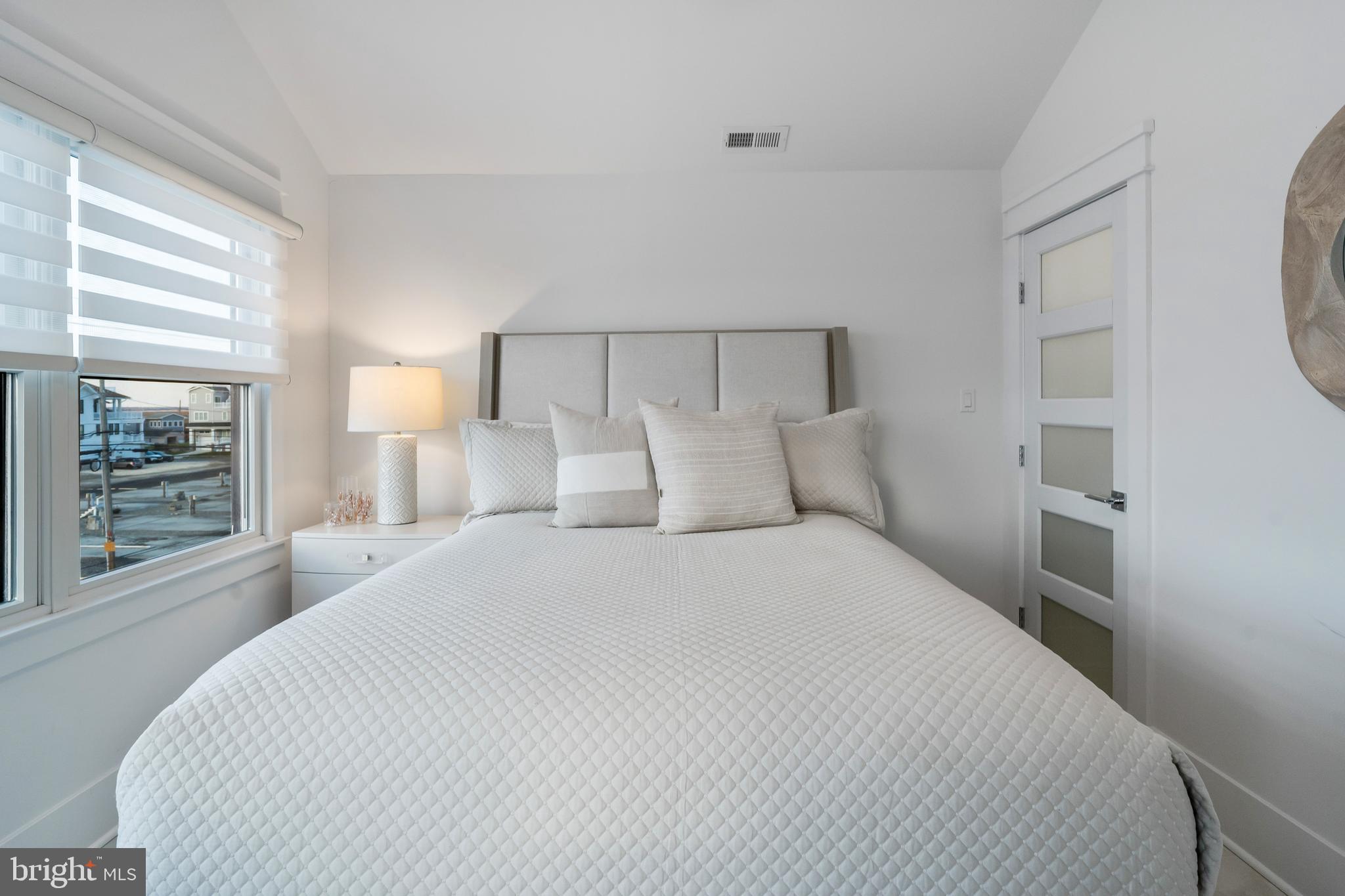 901 South Commonwealth Avenue, Unit SOUTH Strathmere, NJ 08248 - Photo 40 of 66 a bedroom with a large bed and a window