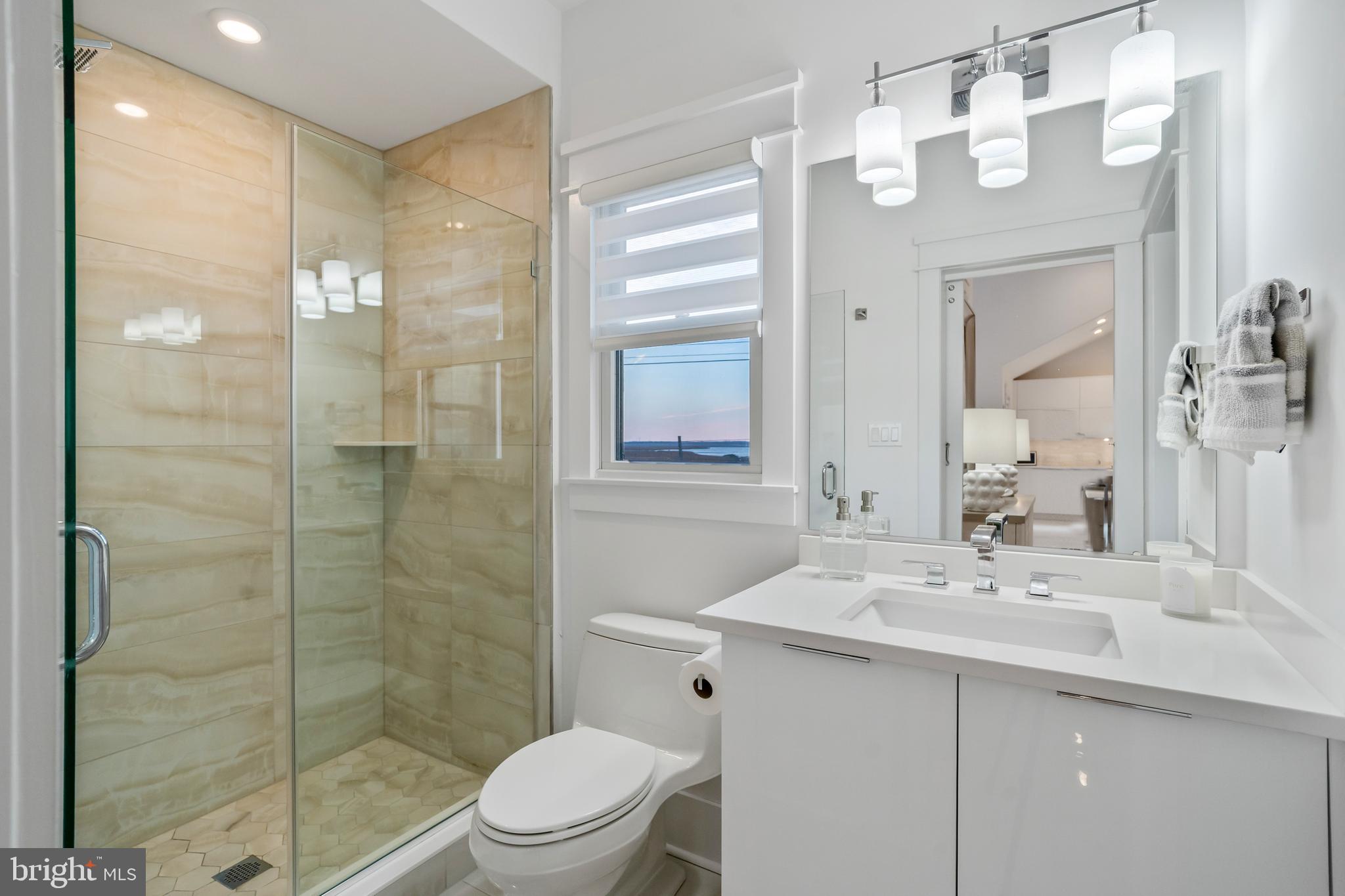 901 South Commonwealth Avenue, Unit SOUTH Strathmere, NJ 08248 - Photo 42 of 66 a bathroom with a sink shower and a mirror