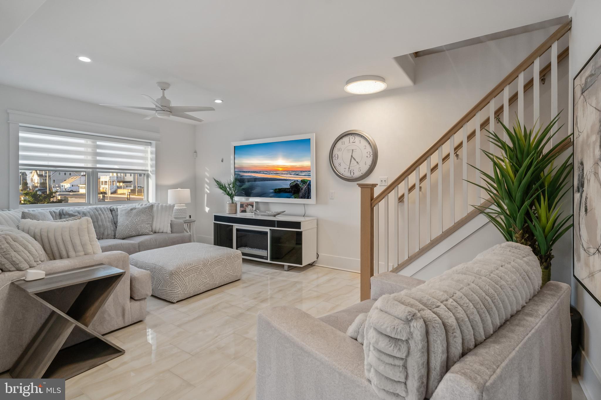 901 South Commonwealth Avenue, Unit SOUTH Strathmere, NJ 08248 - Photo 48 of 66 a living room with furniture a fireplace and a flat screen tv