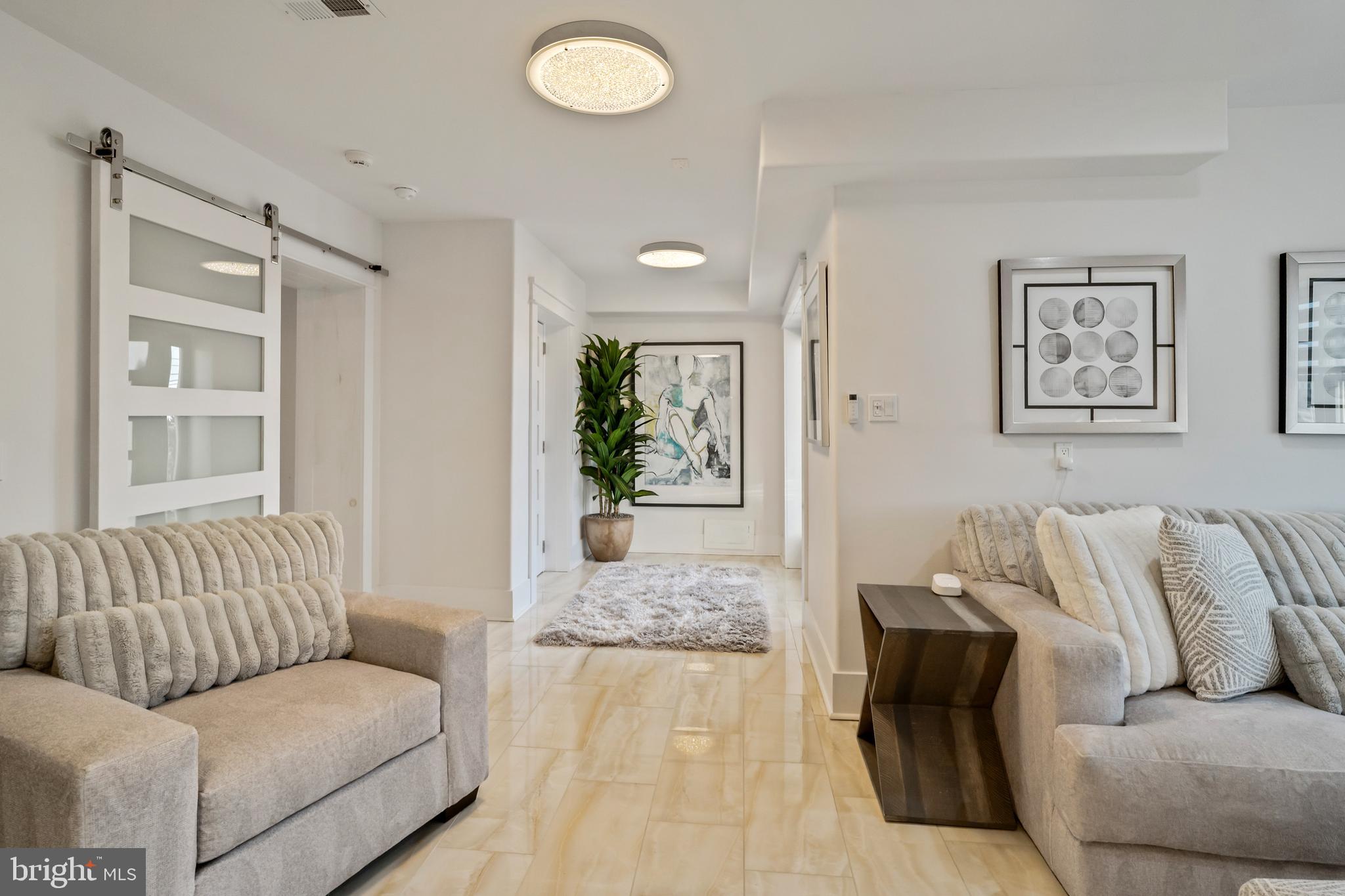 901 South Commonwealth Avenue, Unit SOUTH Strathmere, NJ 08248 - Photo 51 of 66 a living room with furniture and a large window