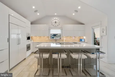 a large kitchen with a table and chairs