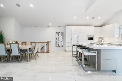 a kitchen with stainless steel appliances a sink stove and cabinets