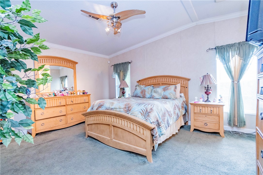 301 Valencia Street Sebastian, FL 32958 - Photo 12 of 29 a bedroom with a bed and a chandelier