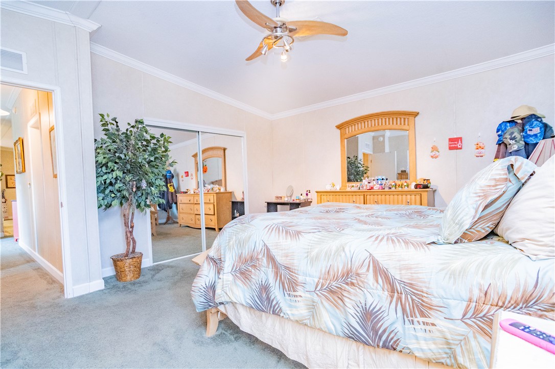 301 Valencia Street Sebastian, FL 32958 - Photo 14 of 29 a bedroom with a bed and a chandelier