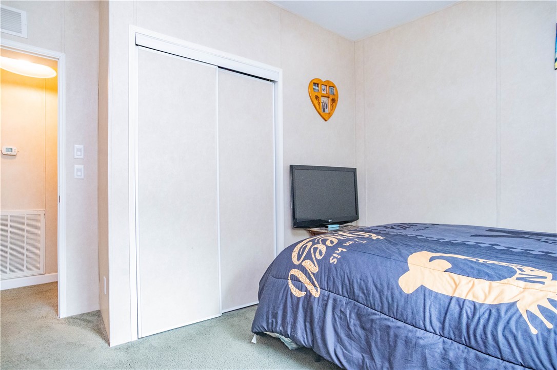 301 Valencia Street Sebastian, FL 32958 - Photo 19 of 29 a bedroom with a bed and painting on the wall