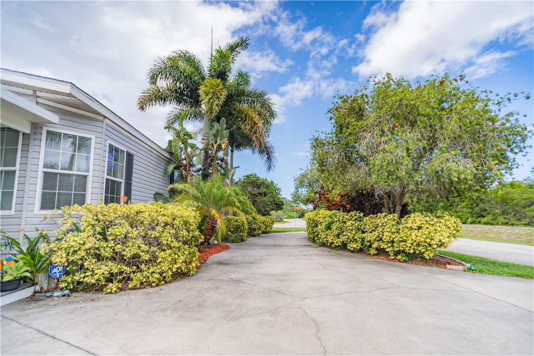301 Valencia Street Sebastian, FL 32958 - Photo 28 of 29 a view of a garden with a potted plant