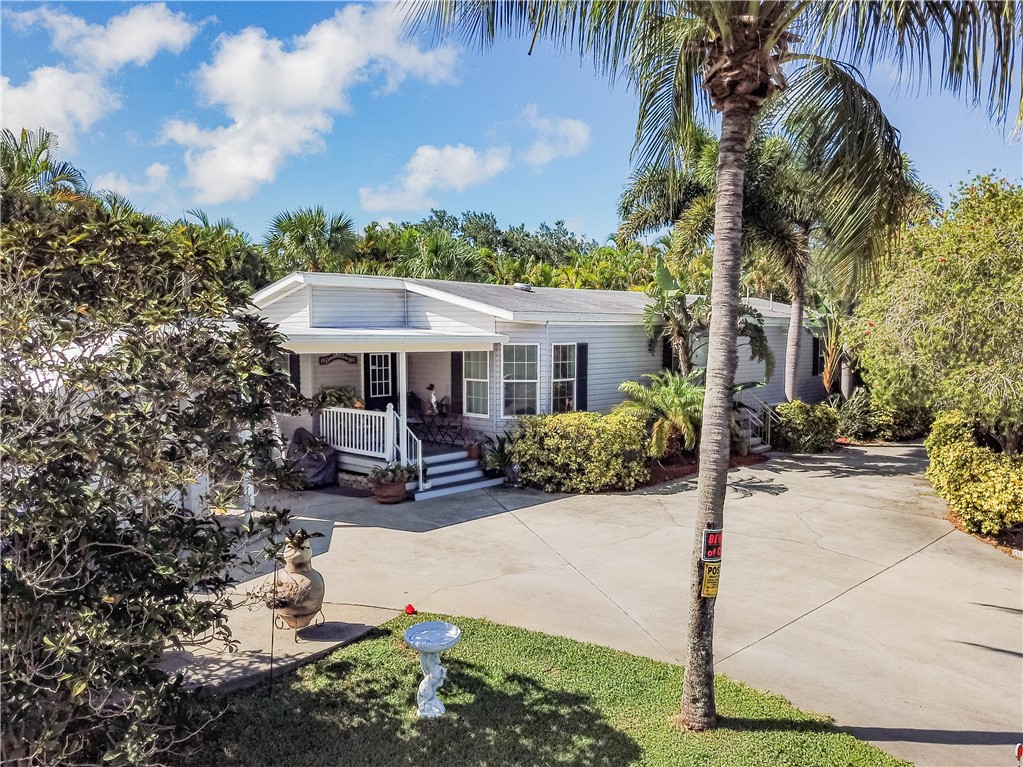301 Valencia Street Sebastian, FL 32958 - Photo 29 of 29 a front view of a house with garden and porch