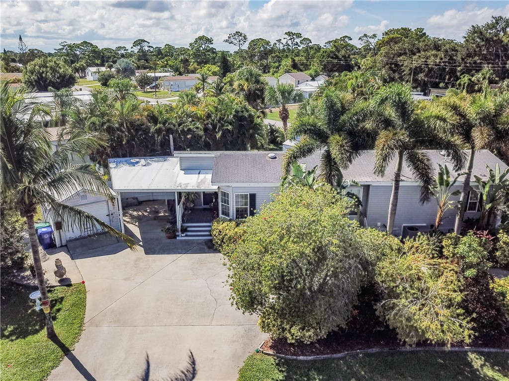 301 Valencia Street Sebastian, FL 32958 - Photo 3 of 29 an aerial view of a house with yard and outdoor seating