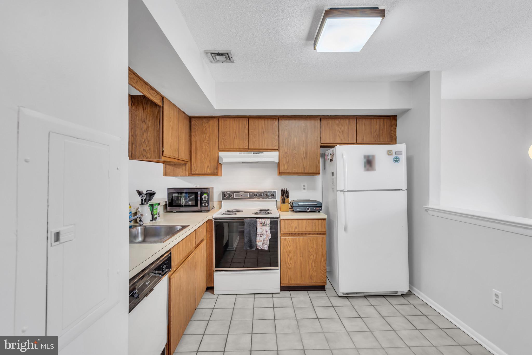 70 Pinewood Drive Hamilton, NJ 08690 - Photo 13 of 40 a kitchen with appliances cabinets and a sink