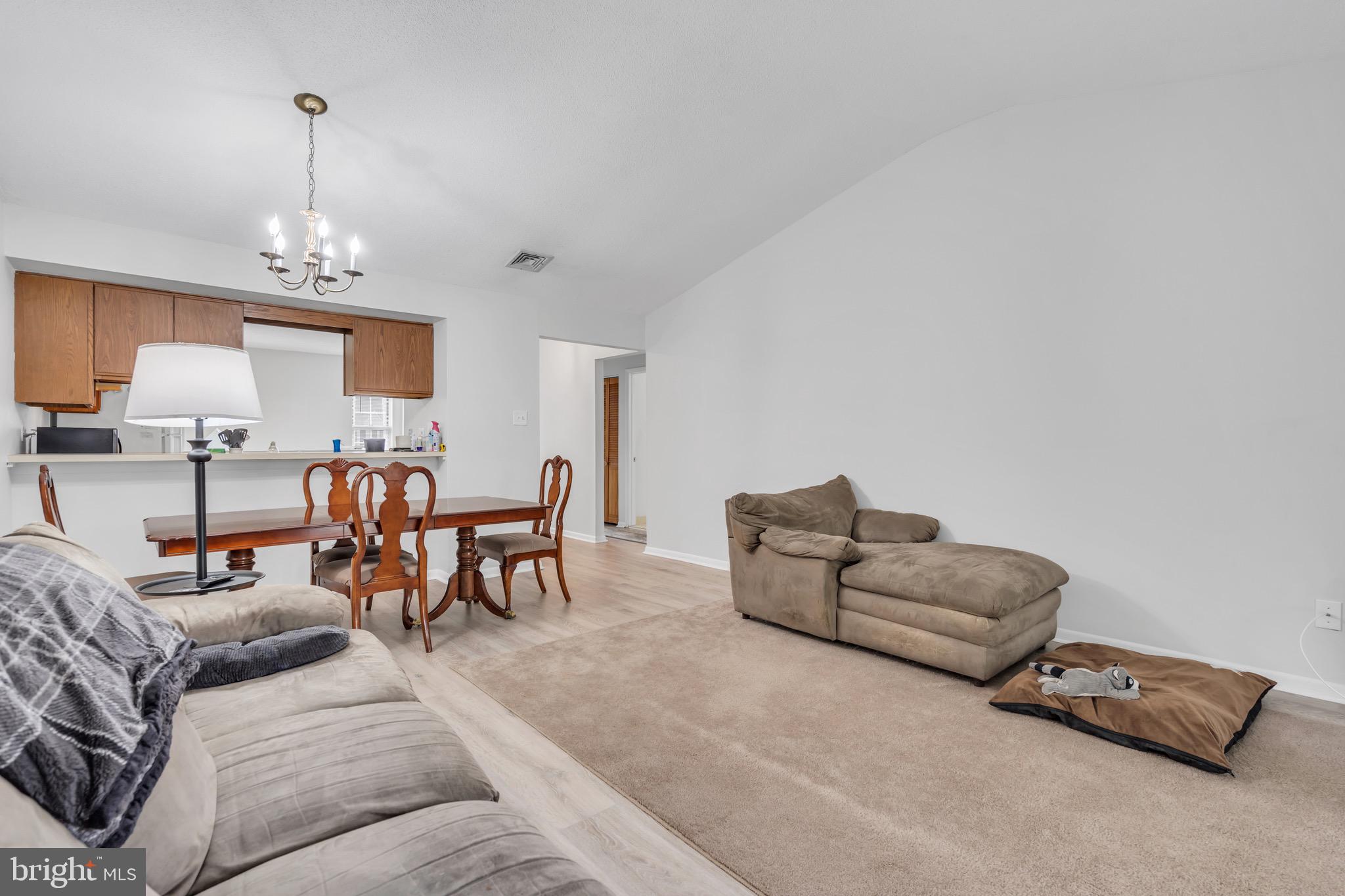 70 Pinewood Drive Hamilton, NJ 08690 - Photo 21 of 40 a living room with furniture and a chandelier