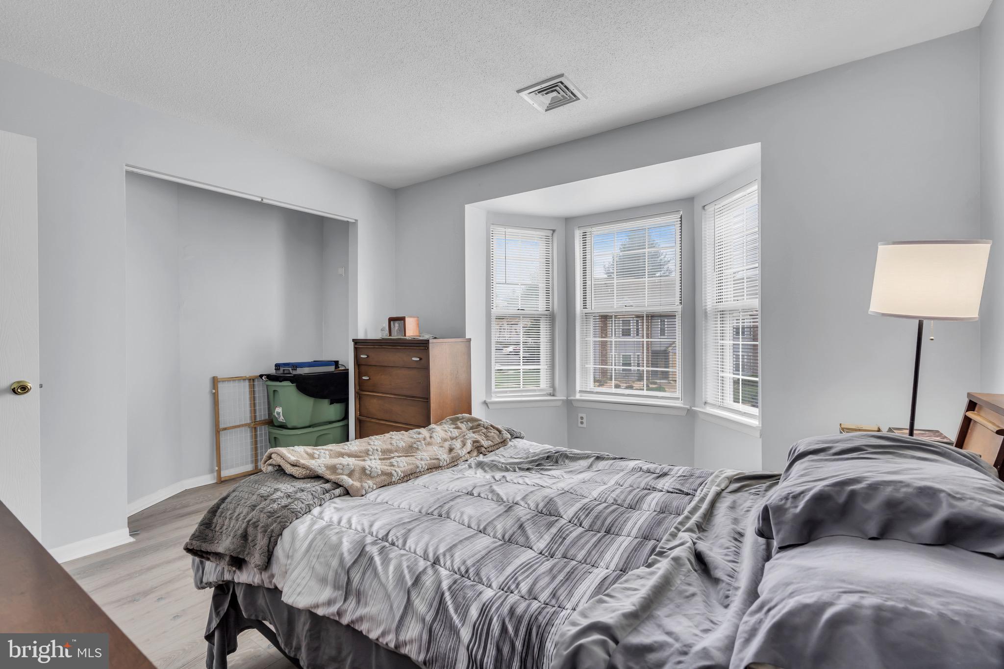 70 Pinewood Drive Hamilton, NJ 08690 - Photo 29 of 40 a bedroom with a bed table and a window