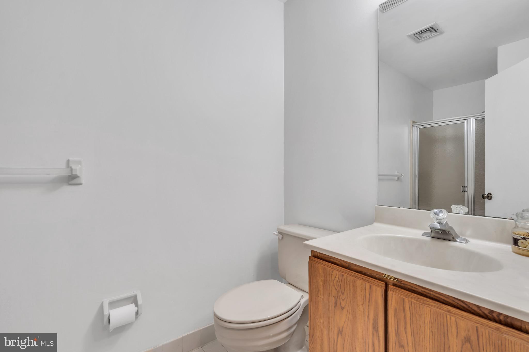 70 Pinewood Drive Hamilton, NJ 08690 - Photo 33 of 40 a bathroom with a sink a toilet and a mirror