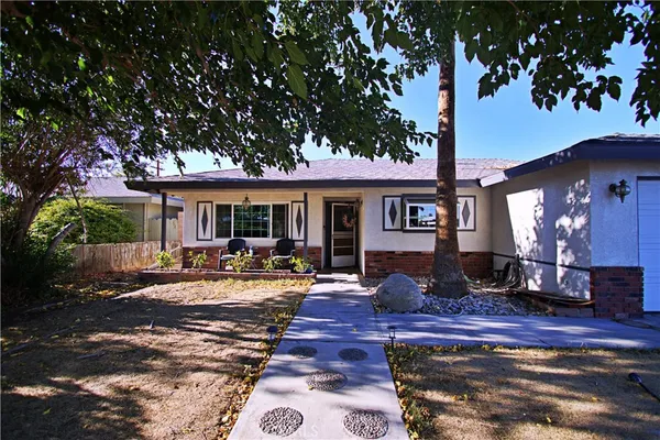 a front view of a house with yard porch and outdoor seating