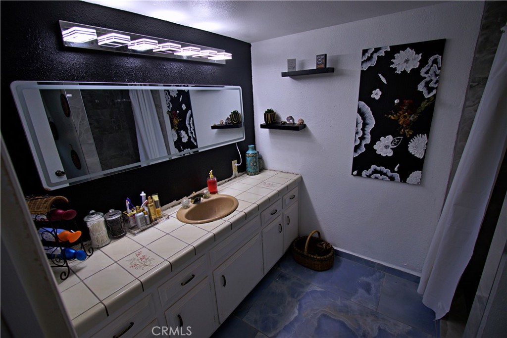 428 West Perdew Avenue Ridgecrest, CA 93555 - Photo 14 of 18 a bathroom with a sink vanity and mirror