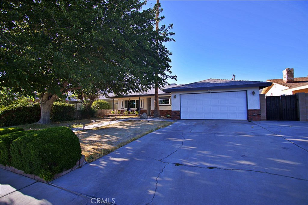 428 West Perdew Avenue Ridgecrest, CA 93555 - Photo 2 of 18 a front view of a house with a yard and a garage