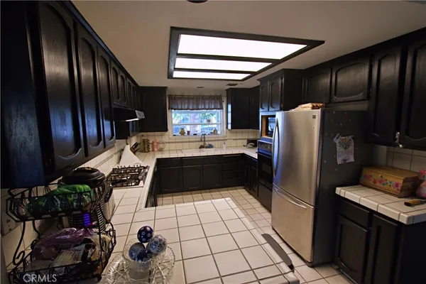 a kitchen with stainless steel appliances a refrigerator sink and stove