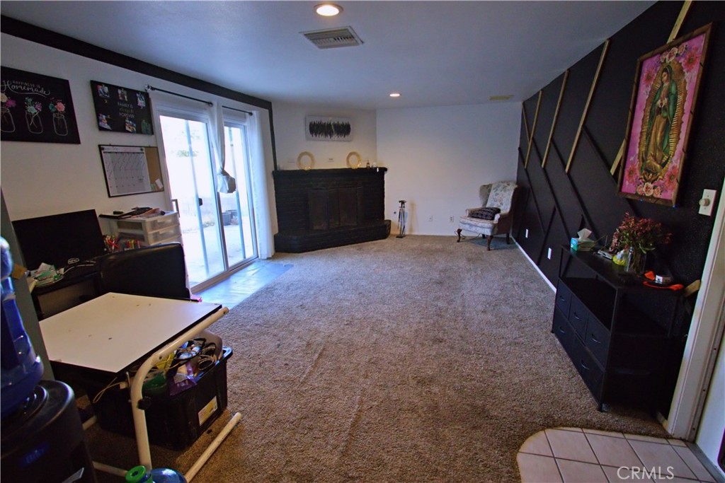 428 West Perdew Avenue Ridgecrest, CA 93555 - Photo 8 of 18 a living room with furniture a flat screen tv and a refrigerator