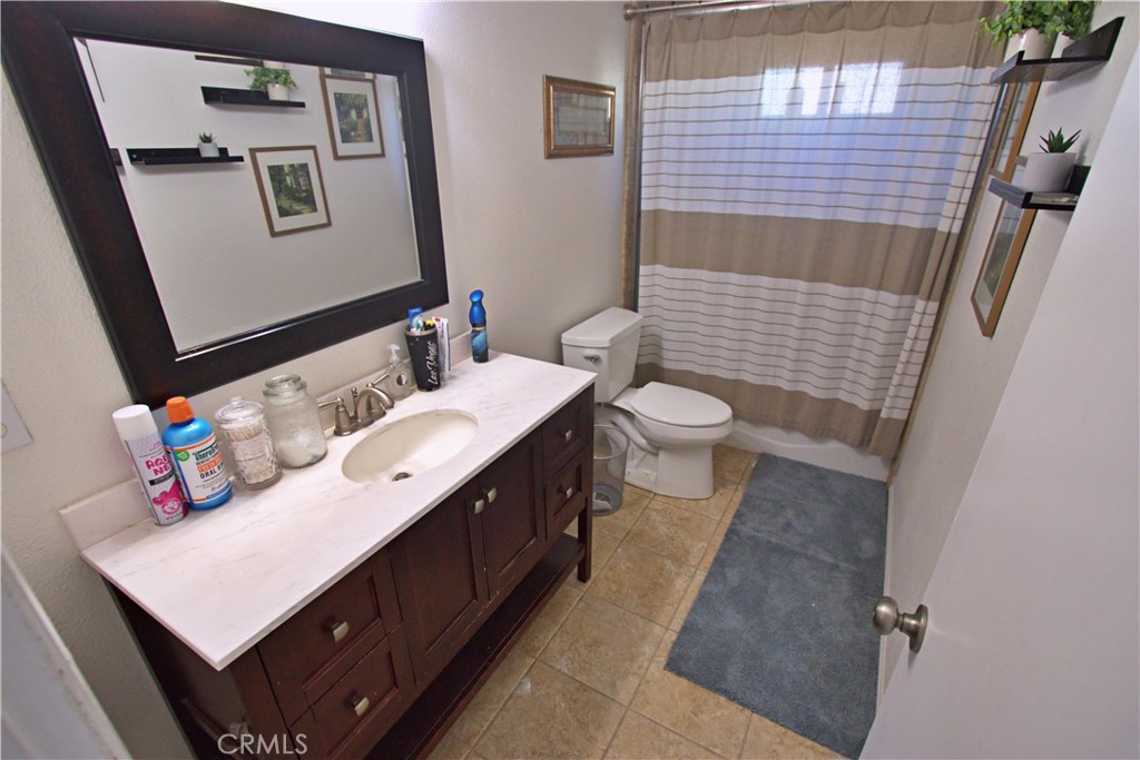 428 West Perdew Avenue Ridgecrest, CA 93555 - Photo 10 of 18 a bathroom with a sink a toilet and mirror