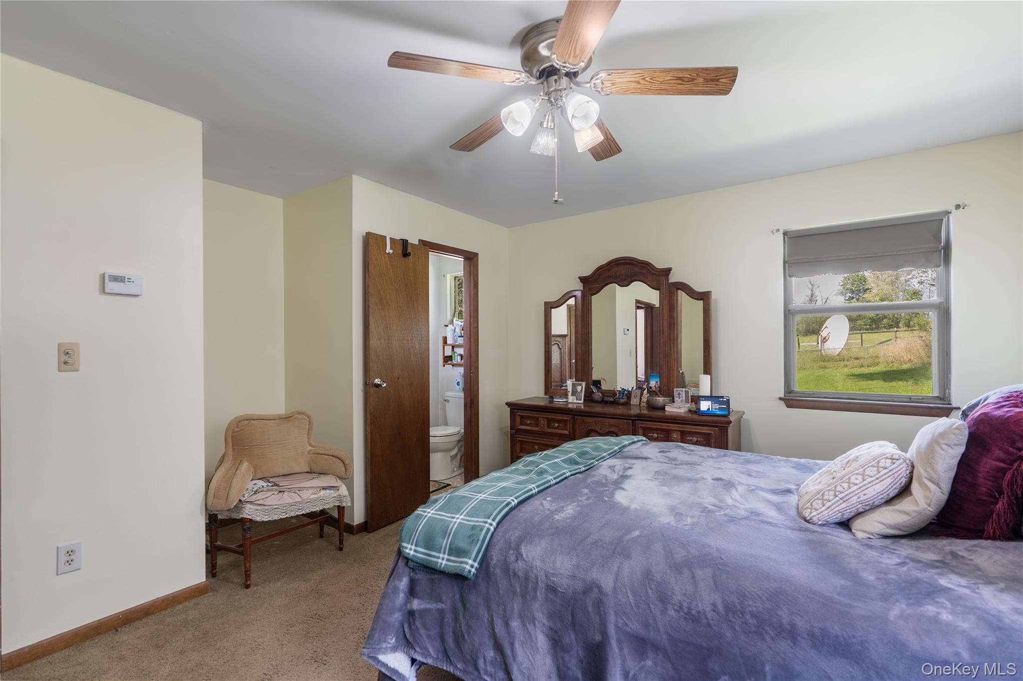 200 Conklingtown Road Goshen, NY 10924 - Photo 38 of 43 a bedroom with a bed and a chandelier