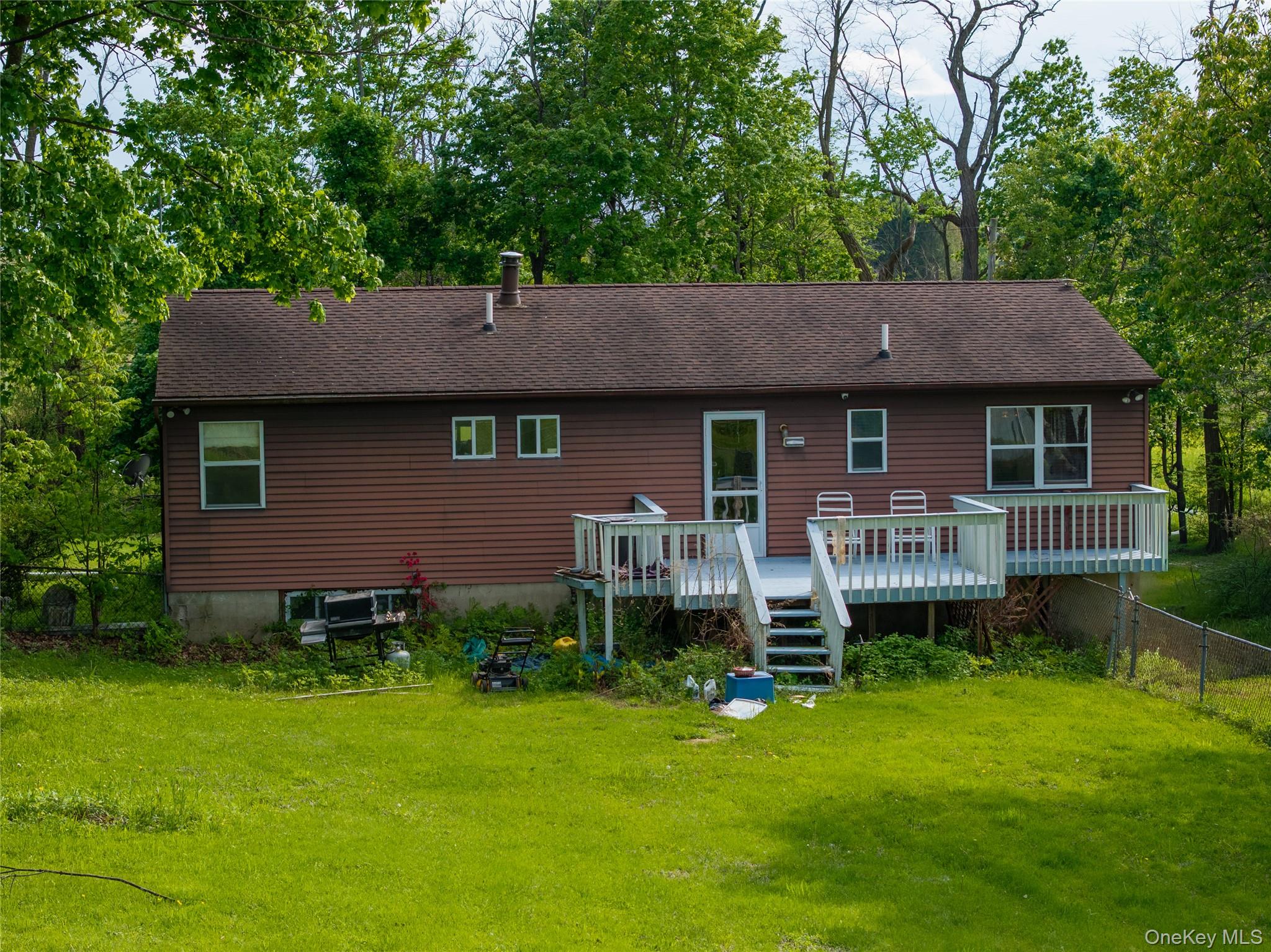 200 Conklingtown Road Goshen, NY 10924 - Photo 9 of 43 a front view of a house with a garden and deck
