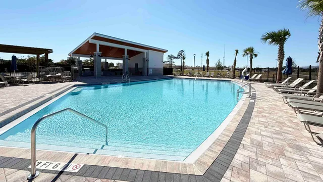 a swimming pool view with a garden space
